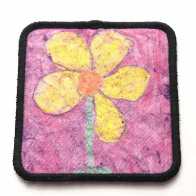 square fabric patch with black border around artwork and adhesive back